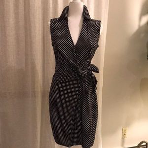 Polka dot black and white wrap dress with a bow.